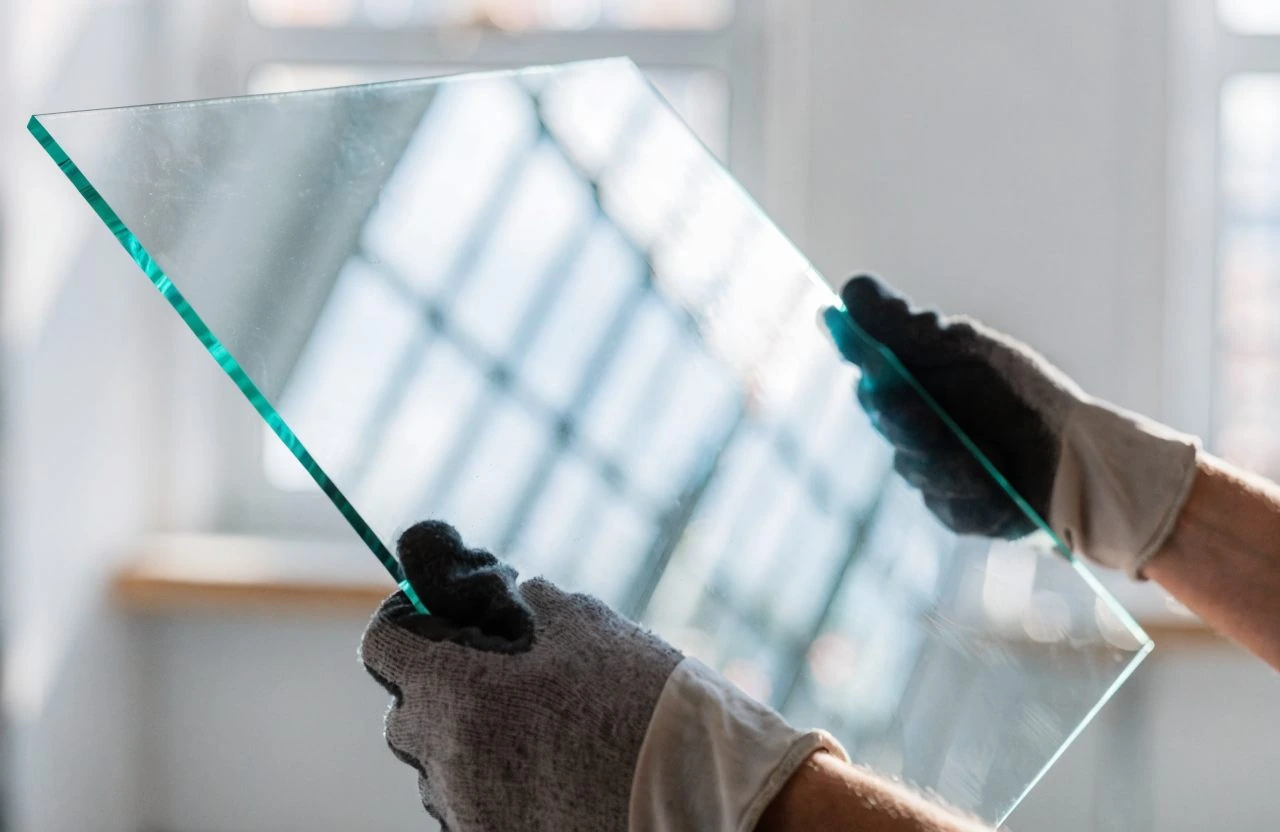 Glazier carrying a glass sheet cut to size at our Wood Green London workshop